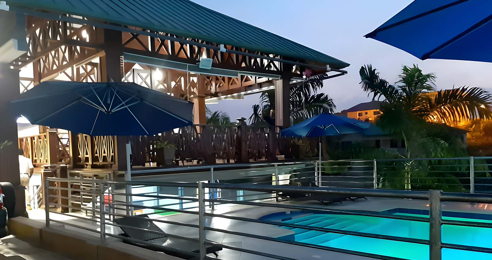 a pool with an umbrella at the side