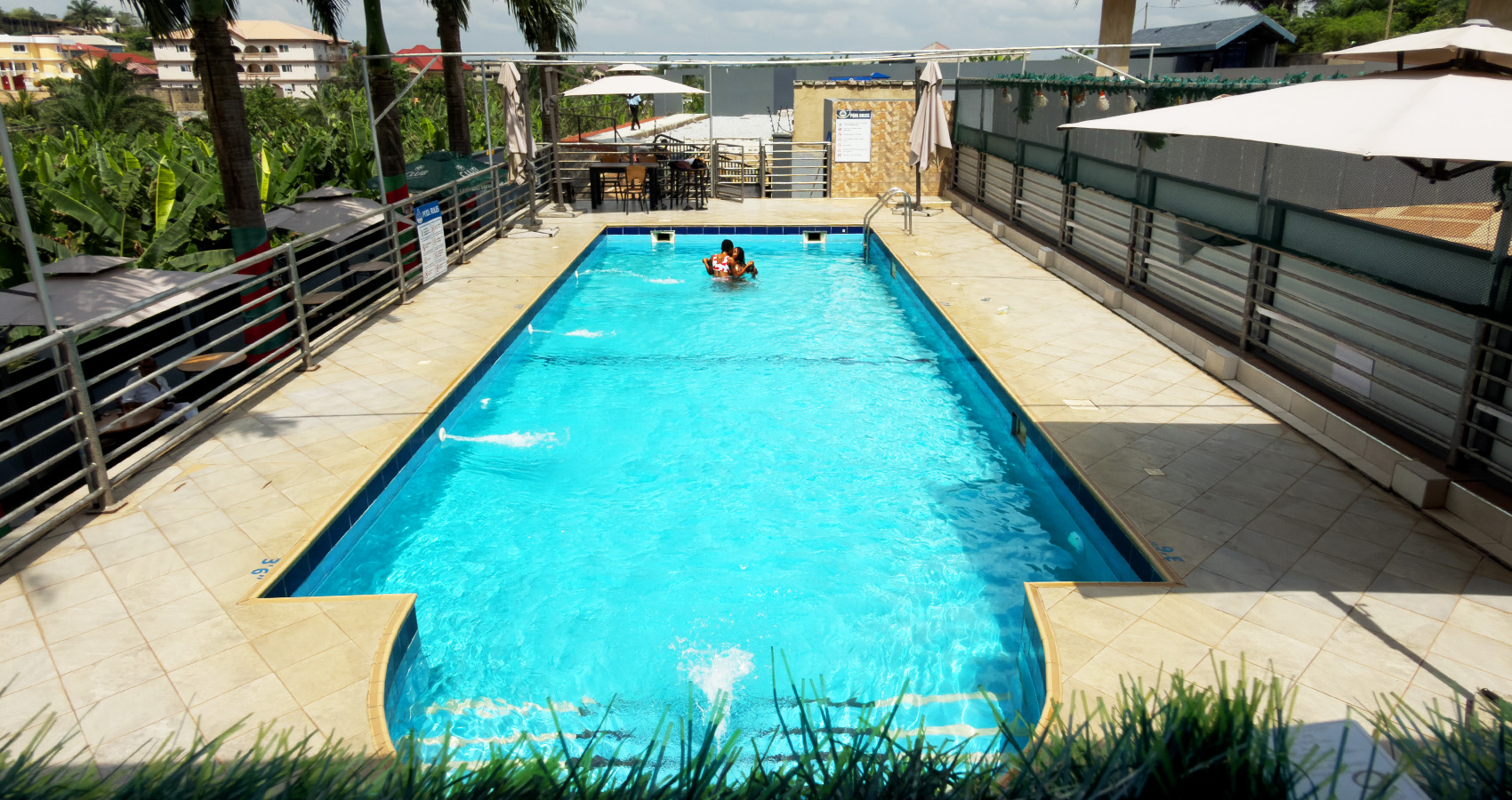 an outside view swimming pool surrounded by modern buildings